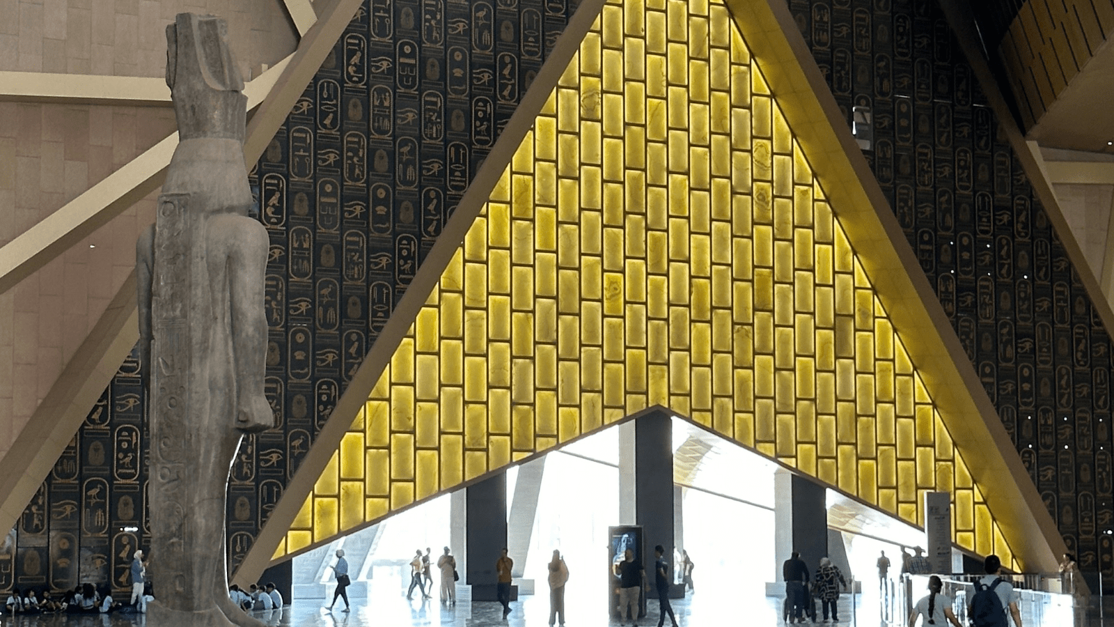Grand Egyptian Museum main hall and staircase with pharaonic statue