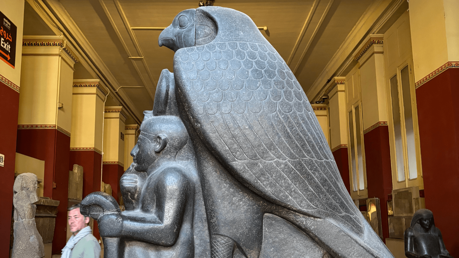 Ancient royal statue protected by a falcon deity inside the Egyptian Museum in Cairo
