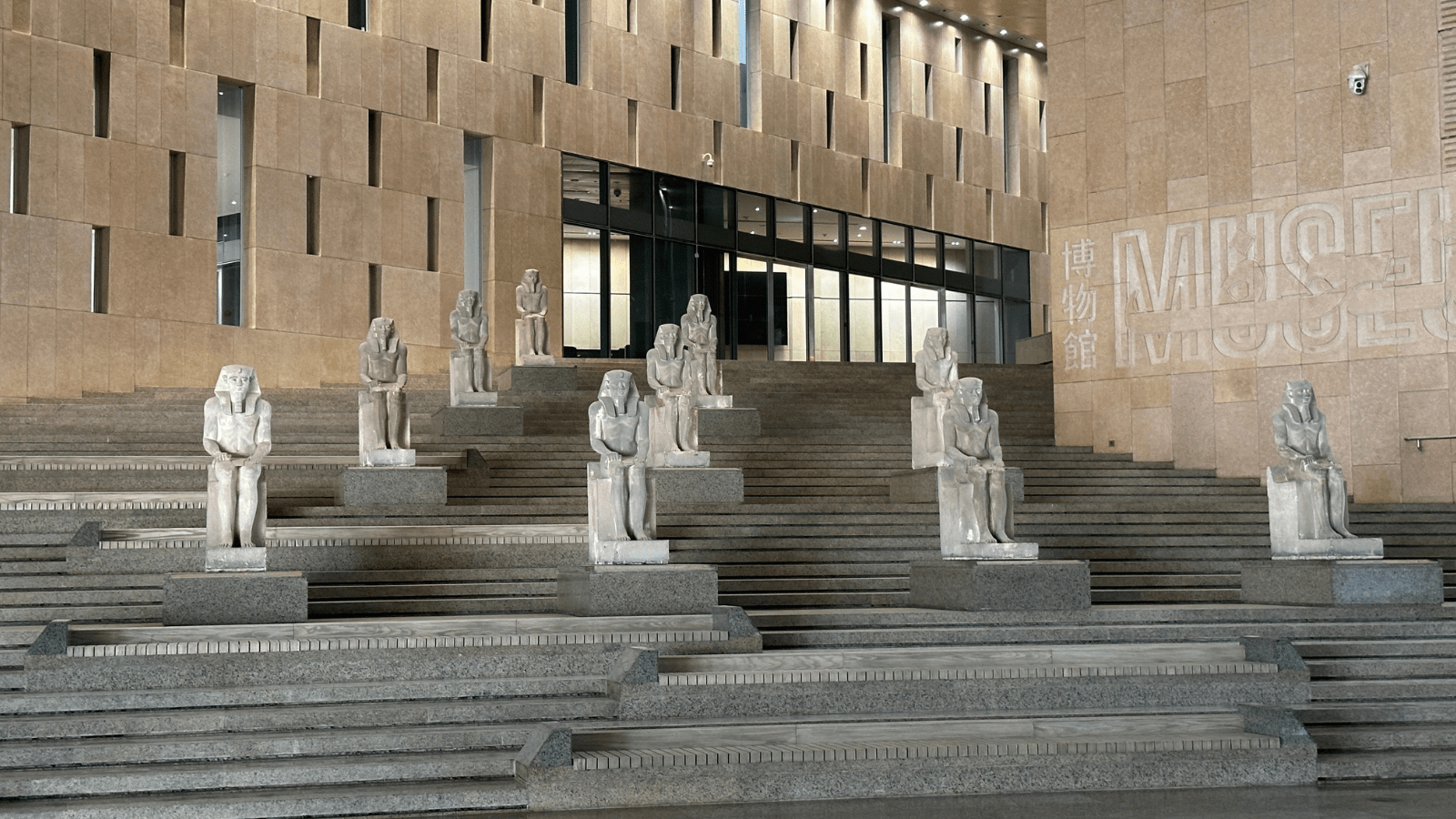 Grand Staircase lined with royal statues inside the Grand Egyptian Museum