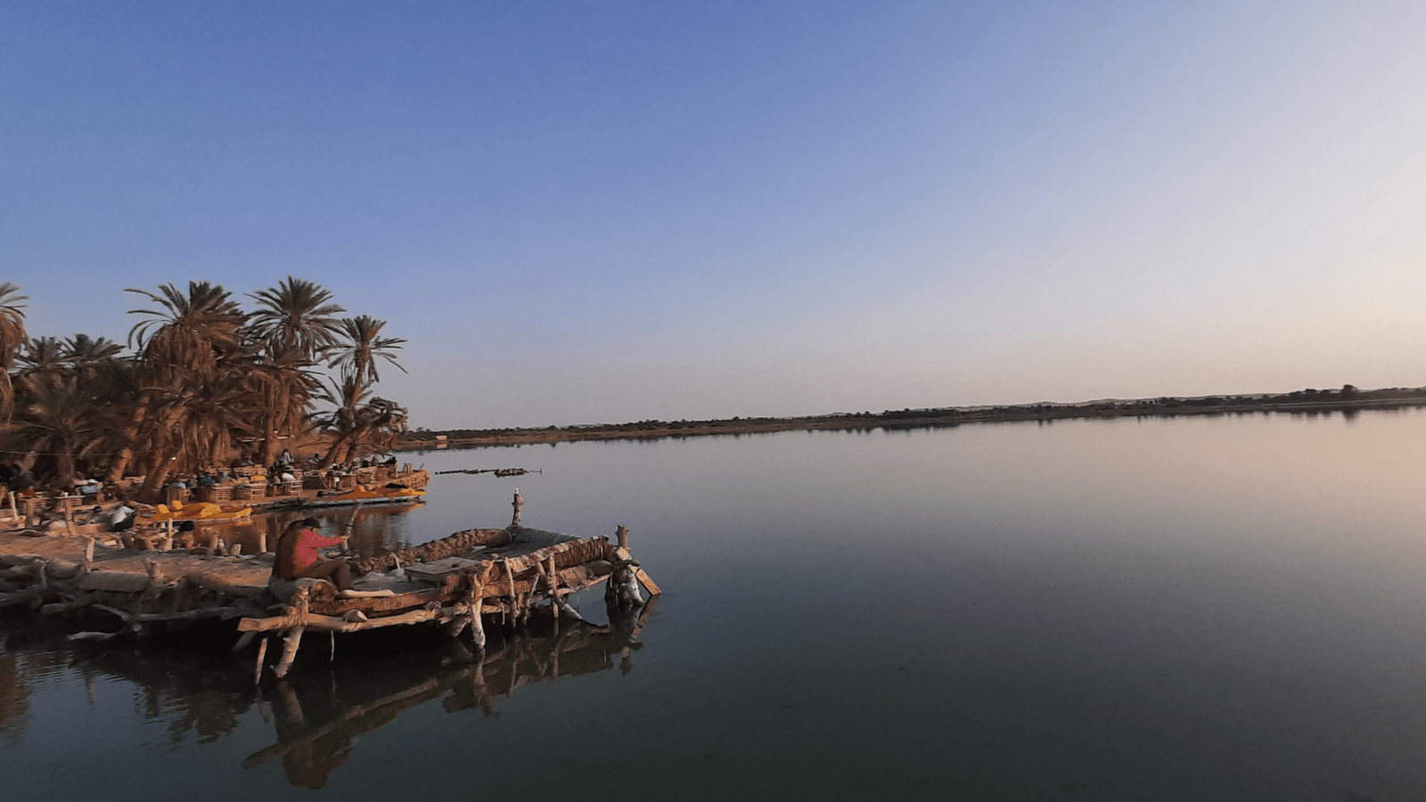Palm-lined lake landscape in Siwa Oasis illustrating the environment surrounding Shali Fortress