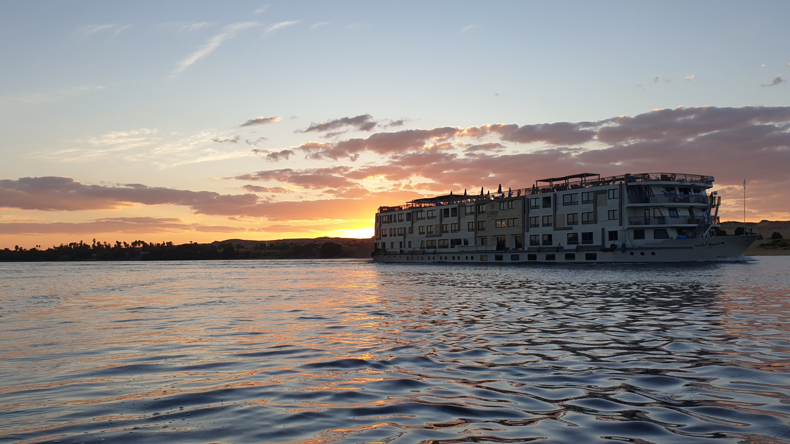 Nile cruise sailing at sunset for a New Year journey from Aswan to Luxor